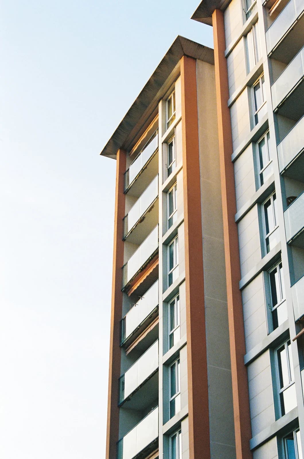 The balconied facade of a mid-rise residential apartment block